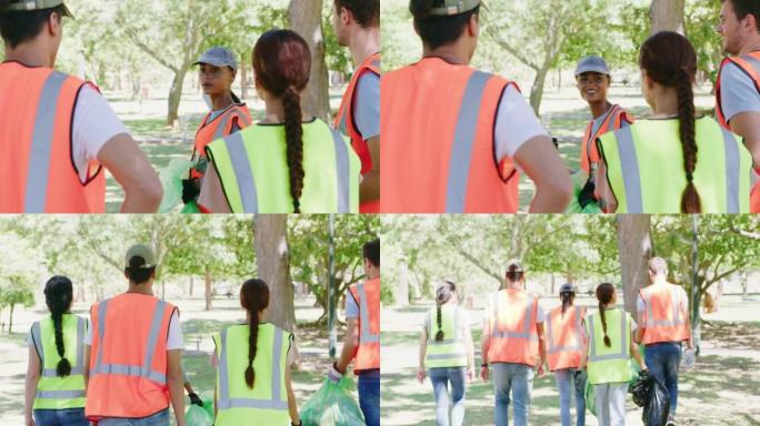 一群面带微笑的社区工作者团结起来，提供户外清洁服务或项目。年轻的快乐志愿者在公园收集垃圾进行回收之前