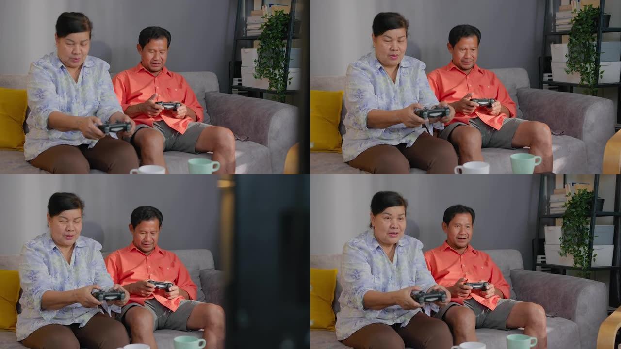 退休亚洲老年人在家客厅玩电子游戏。