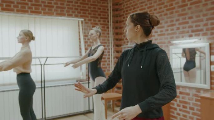 SLO MO芭蕾舞大师在工作室教授两名年轻的女芭蕾舞演员