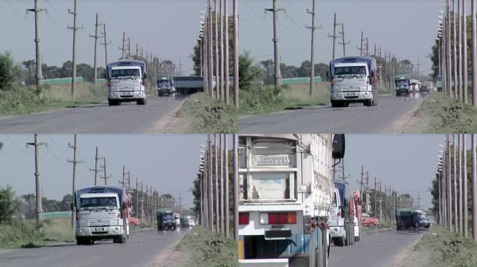 阿根廷圣达菲省乡村公路上的汽车和卡车。