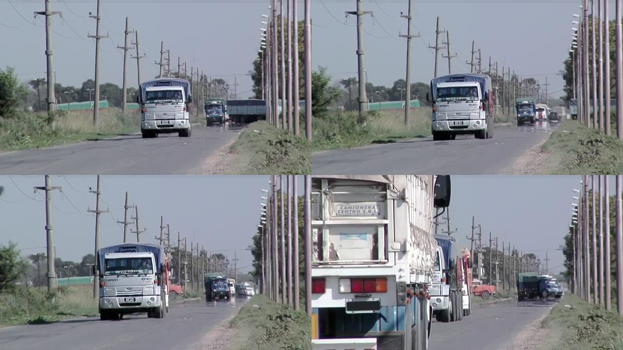 阿根廷圣达菲省乡村公路上的汽车和卡车。