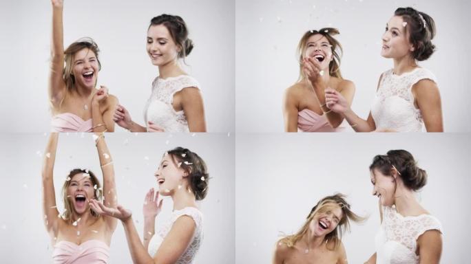 一个年轻新娘在工作室背景下与朋友吹泡泡的4k视频片段