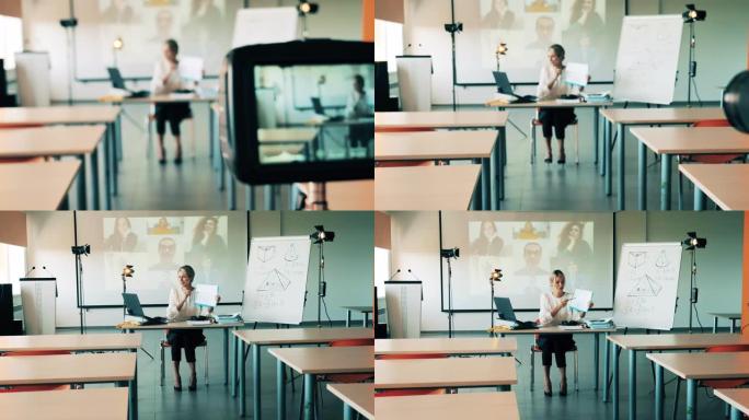 一名正在网上上课的妇女正在空荡荡的教室里被拍摄。在线课堂，远程学习概念。