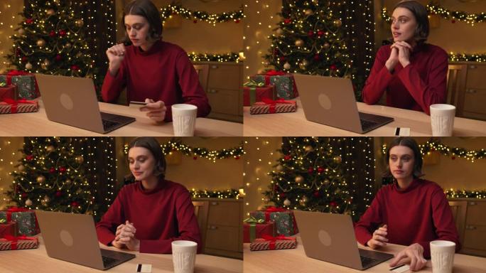 一个穿着红色毛衣的年轻迷人女人正在笔记本电脑上网上购物