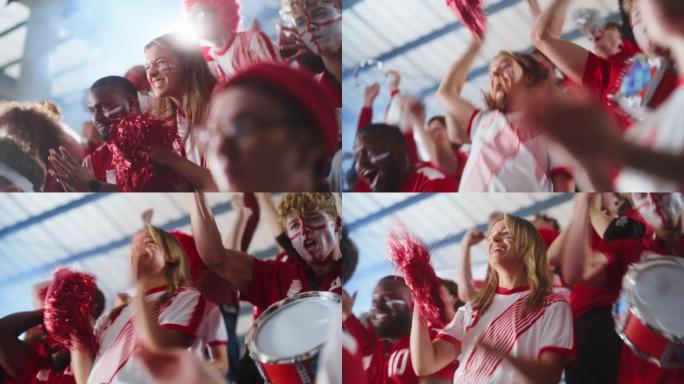 体育馆体育赛事: 美丽的欢呼女孩。一群脸上涂着彩绘的球迷欢呼，为他们的红色足球队获胜而呐喊。人们庆祝
