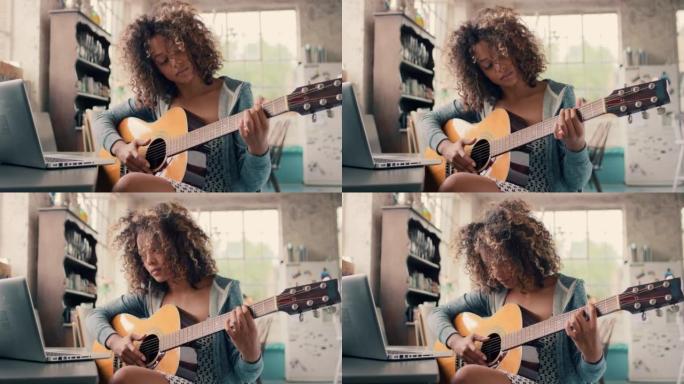 4k视频片段，一名妇女拿着笔记本电脑坐在家里弹吉他