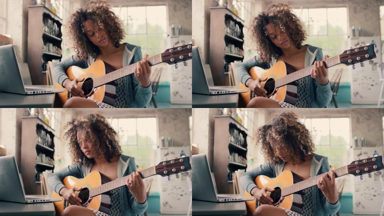 4k视频片段，一名妇女拿着笔记本电脑坐在家里弹吉他