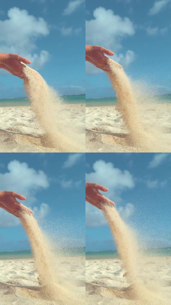 垂直慢动作白沙粒在风中飞离女人的手