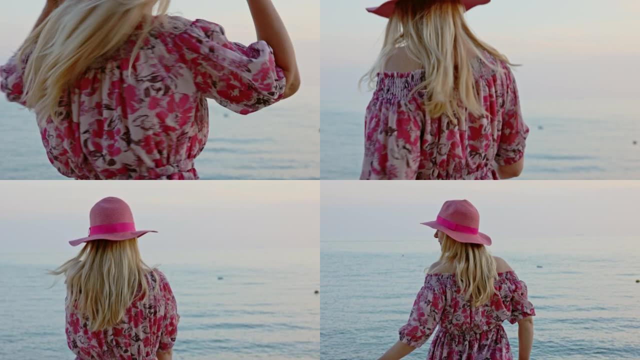 特写金发女子，戴着粉色帽子，穿着在海上跳舞