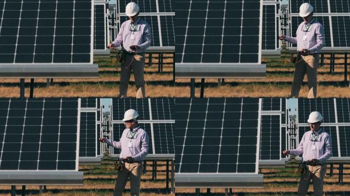 能源工程师用万用表监控太阳能电池板。太阳能概念。