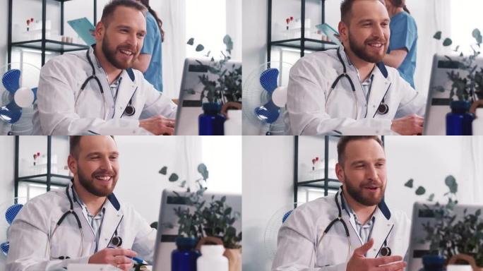 快乐微笑的白人男性医生穿着实验室外套，听诊器通过笔记本电脑网络摄像头视频在线与远程客户交谈。