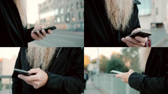在城市中使用智能手机的留着长胡须的女士