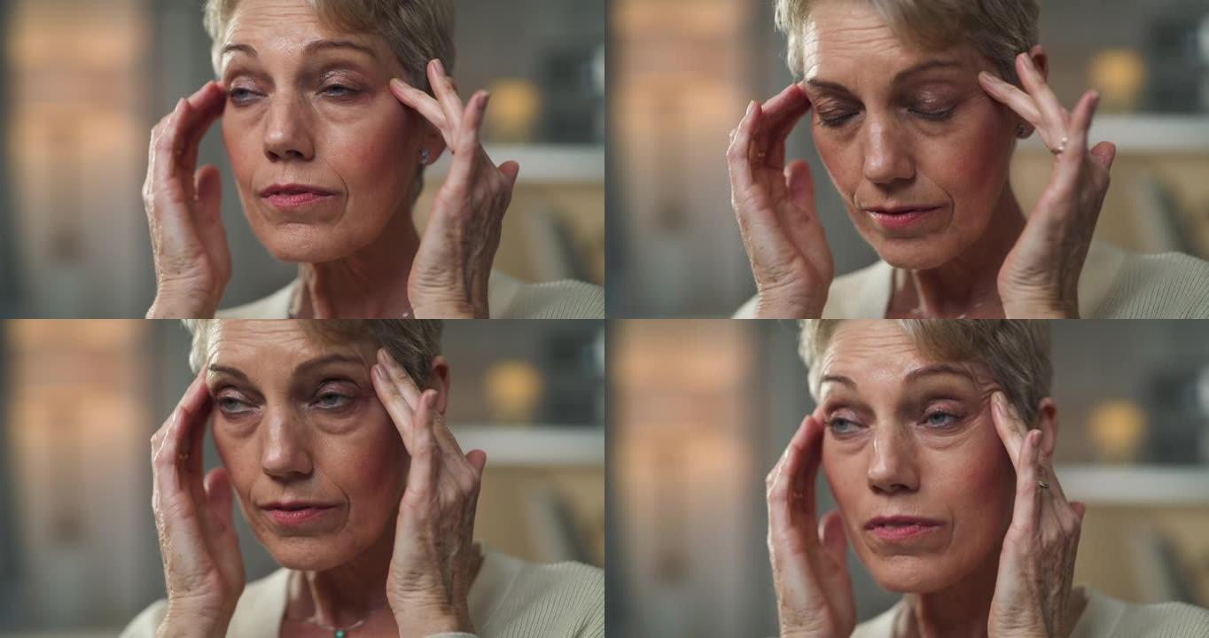 4k视频片段，一名老年妇女坐在家里头痛