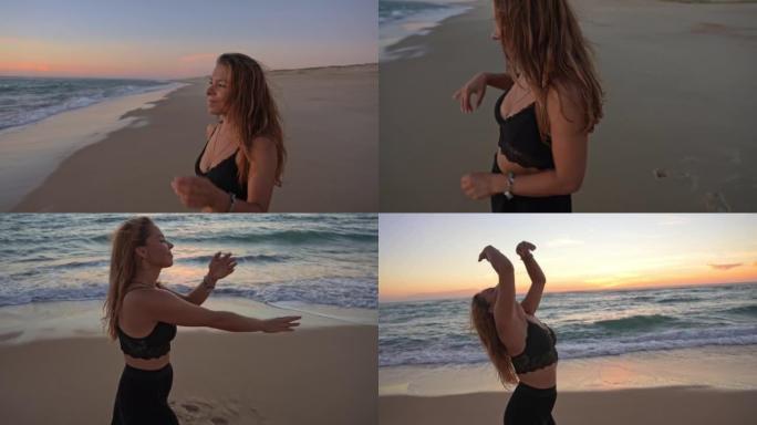 年轻女子女士在日落时在海滩上跳舞很有趣