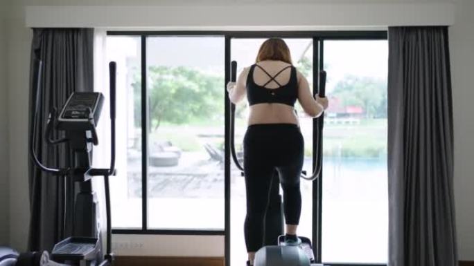 孕妇在健身室锻炼，使用椭圆形身体健康
