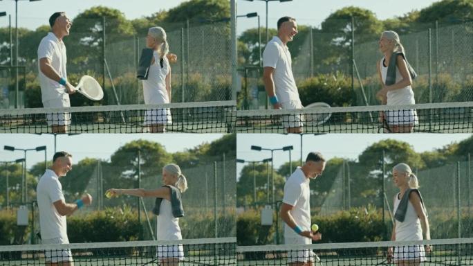 顽皮的夫妇站在网球场上聊天