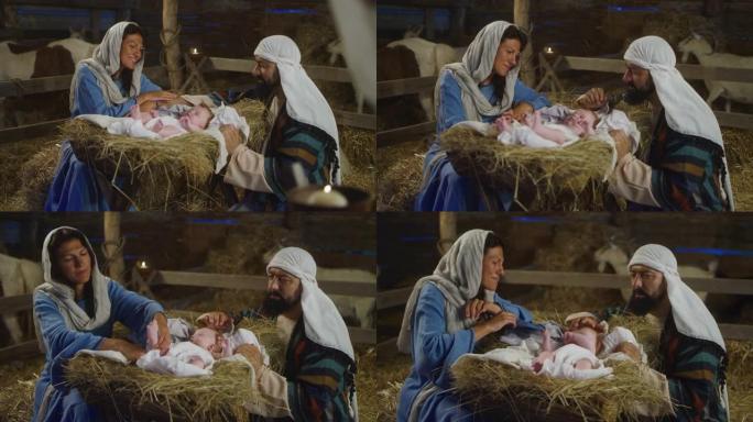 快乐的玛丽和约瑟夫和小耶稣在摊位附近