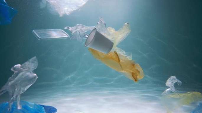 塑料垃圾问题。慢动作各种一次性包装废料漂浮在污染海洋的水下慢动作。