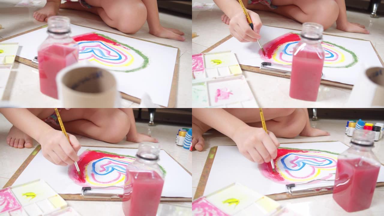 亚洲小女孩在家时在客厅绘画和绘画她的艺术和工艺。她喜欢用水彩和画笔在白纸上创作艺术作品，并从中获得乐