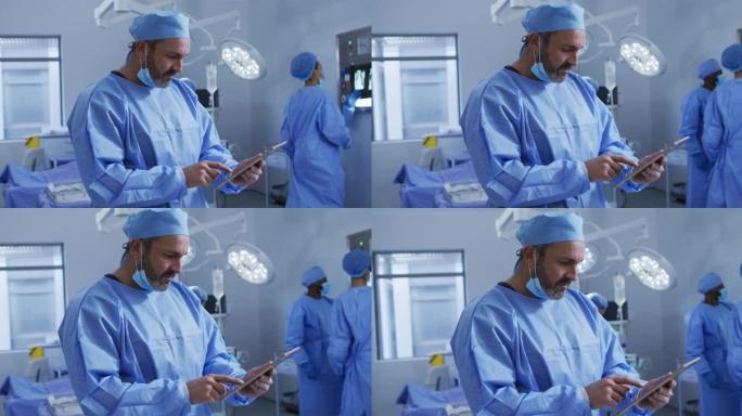 使用平板电脑站在手术室的高加索男性外科医生的肖像