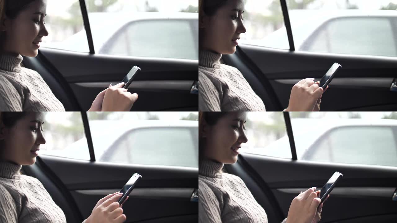 在汽车上使用智能手机的女人
