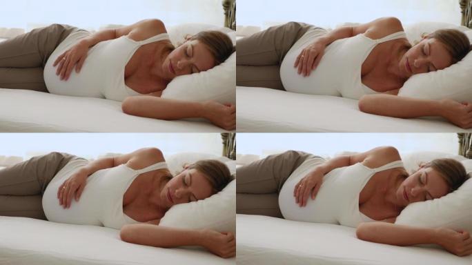 Serene pregnant woman sleeping in bed, closeup
