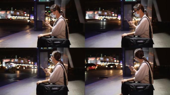 亚洲妇女使用移动应用程序在晚上叫出租车
