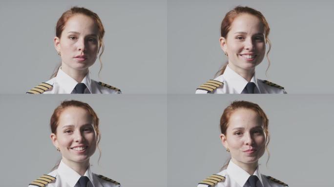 工作室在朴素的背景下微笑的女飞行员或船长的肖像