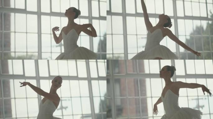 美丽、优雅的芭蕾舞演员在舞蹈室练习她的动作和动作。年轻优雅的表演者在活跃，灵活和女性化的同时排练舞蹈