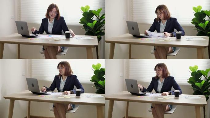 使用笔记本电脑和平板电脑在线会议的女商人视频会议。在家工作