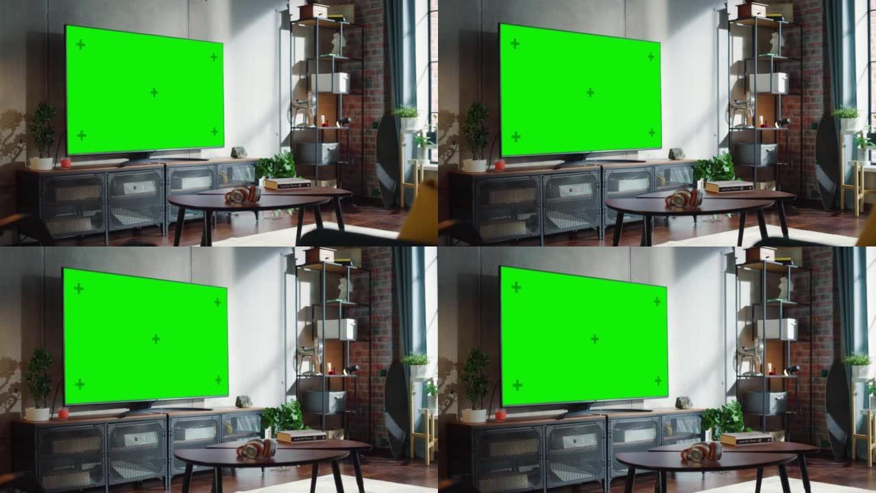 简单阁楼客厅现代控制台上的绿色大屏幕电视。房间中间有绿色色度键电视。放大相机拍摄