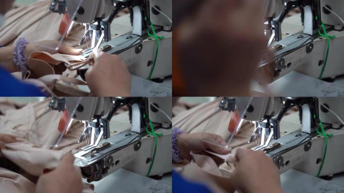 工人使用缝纫机服装厂加工制作特写镜头