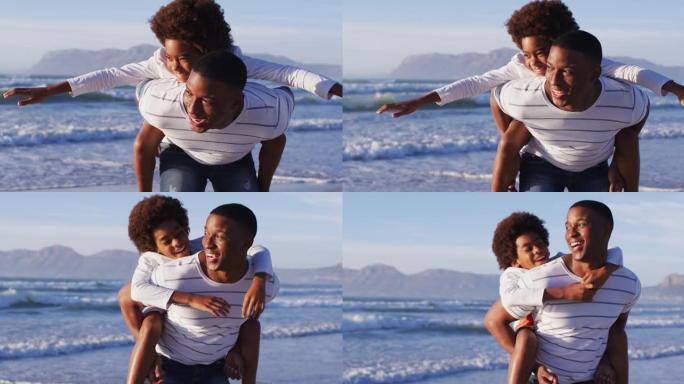 非裔美国父亲在海滩上背着他的儿子