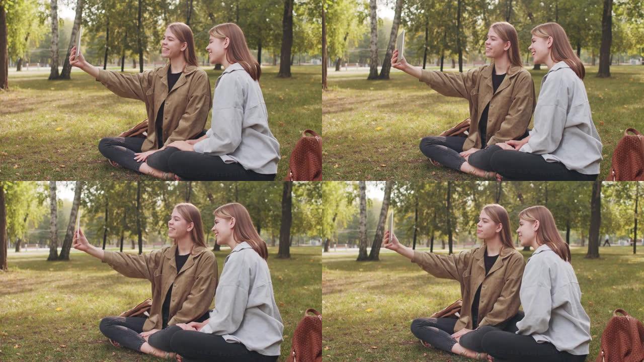 快乐的双胞胎在公园里进行视频通话