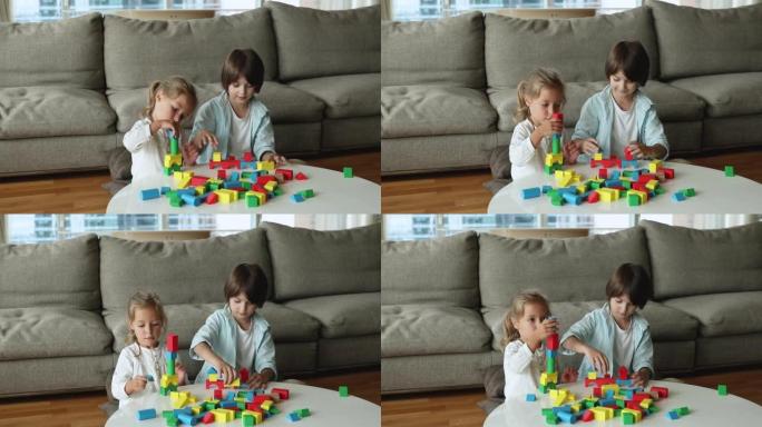 两个专注可爱的兄弟姐妹孩子在家里玩积木