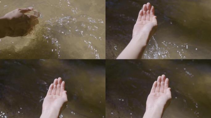 人类的手在湖里取水。