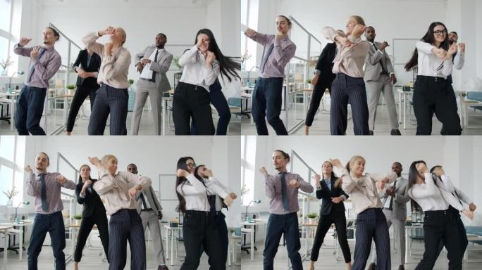 创意员工在办公室跳舞的慢动作，开心的脸看着相机