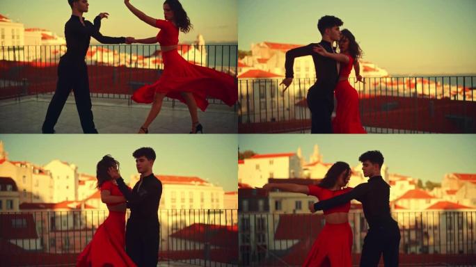 美丽的夫妇在城市外跳拉丁舞，背景是老城区。在古老的文化底蕴丰富的旅游地点，由两名专业舞者在日落时进行