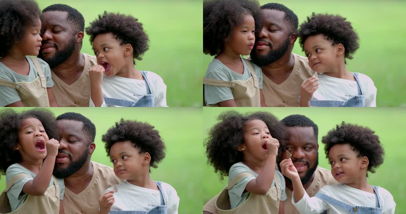 一对父子，一个黑人女儿，在公园玩耍。所有人在一起度过幸福的时候，每个人的脸上都在微笑。