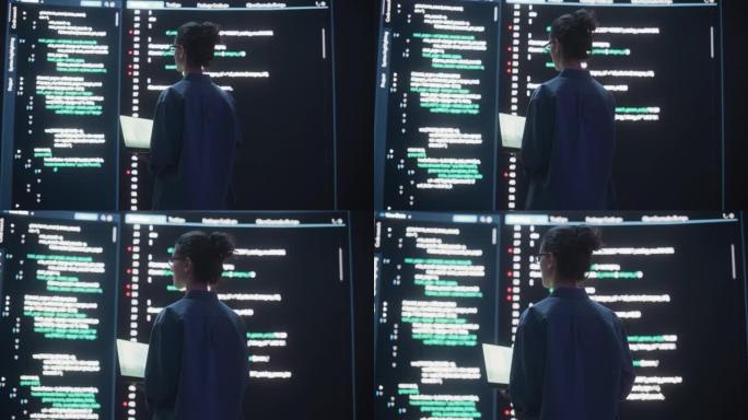 女人创建软件和编码的后视图，周围是大屏幕，显示编程语言代码行。在监控控制室工作的女程序员。未来主义概