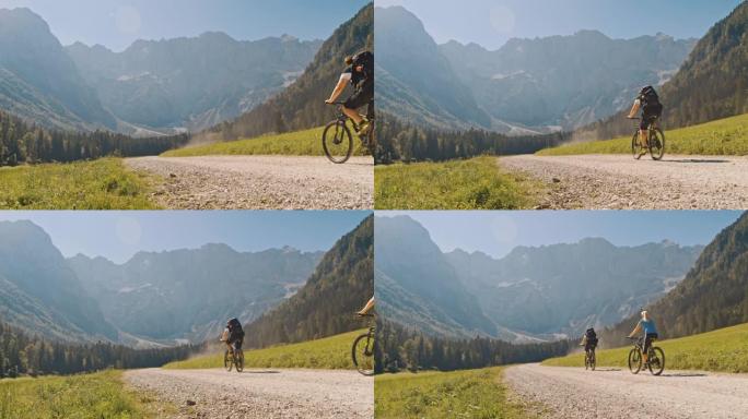 SLO MO自行车手在山下的乡间小路上骑行