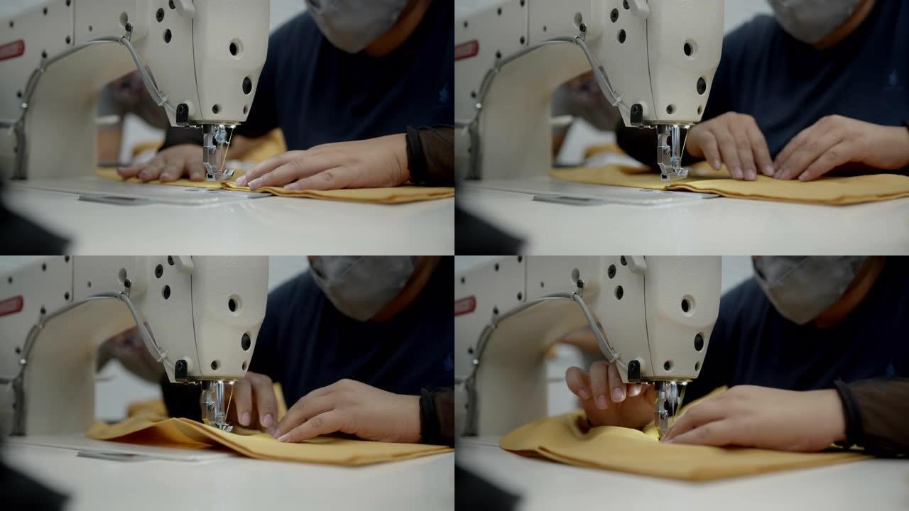 在缝纫机上的工作站在纺织厂工作的无法辨认的妇女的特写