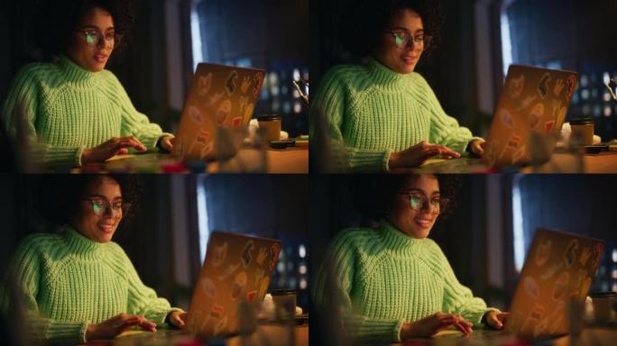 积极的黑人女性软件工程师在她的工作室里与灵感一起工作时，在笔记本电脑上编码。女人晚上学习很晚。远程工