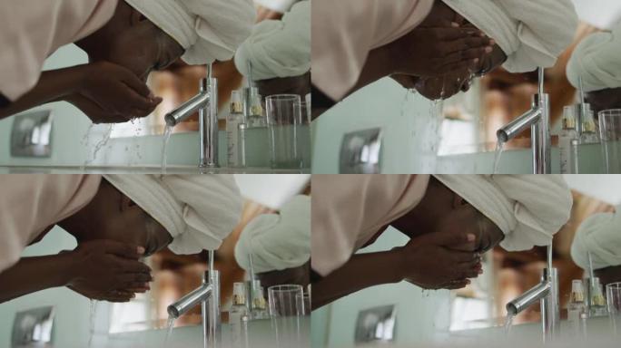 非裔美国迷人的女人在浴室洗掉口罩