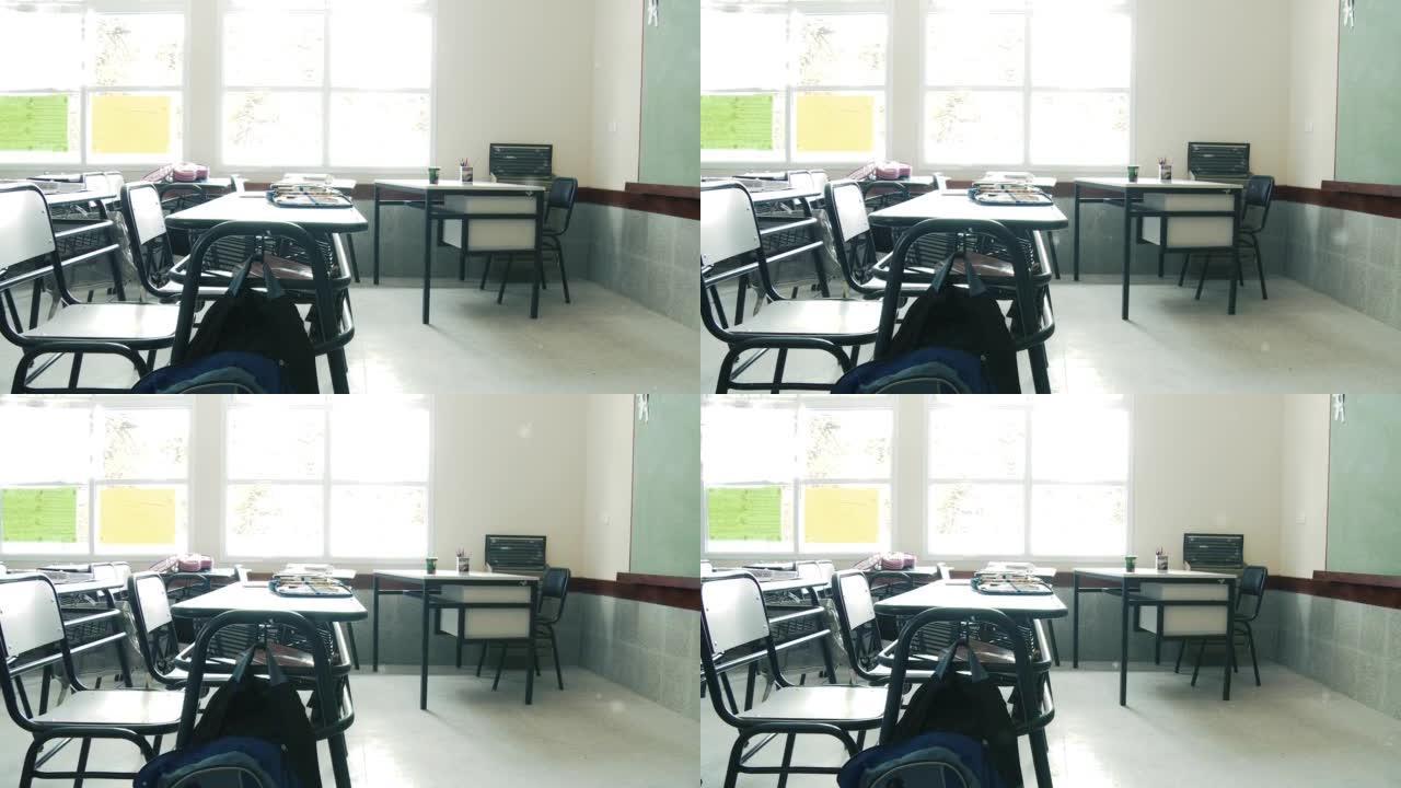 空荡荡的学校教室里一排排的桌子。缩小。