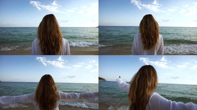 一位年轻无忧无虑的女性游客的真实照片感到自由，并在海景上走向