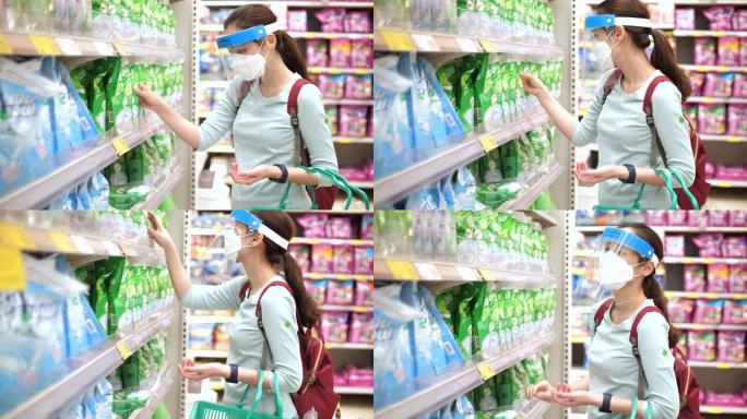 超市里戴着口罩的亚洲女人