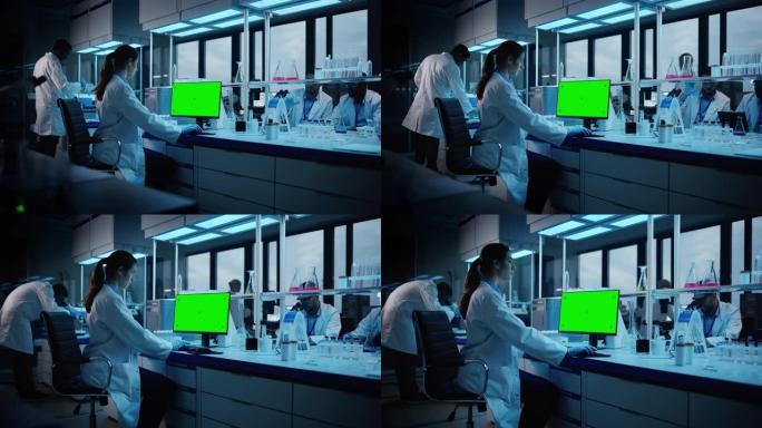 现代医学研究实验室: 在计算机上工作的女性科学家的肖像，显示绿色色度键屏幕。先进科学实验室，医药开发