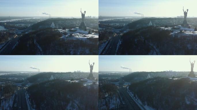 美丽的空中全景，著名的阳光明媚的冬季基辅地标，祖国纪念雕像对着汽车高速公路。