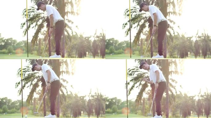 高尔夫球手以慢动作庆祝。职业亚洲男子高尔夫运动员在高尔夫比赛运动中将高尔夫球放入洞中后，为成功投篮感